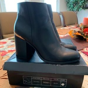Black ankle booties with gold accent on heel